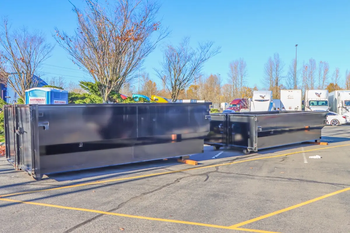 Professional dumpster rental service with roll-off container on residential driveway in Dodgeville